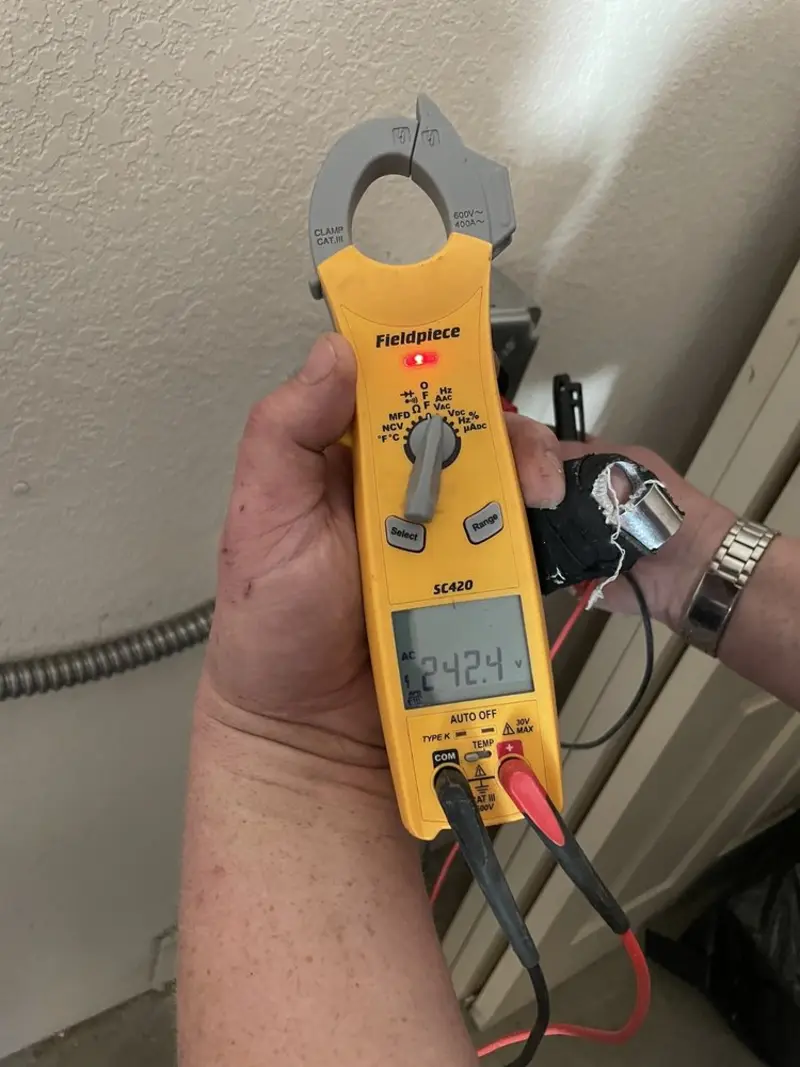 Voltage testing with clamp meter during Ceiling Fan Installation in St. Charles